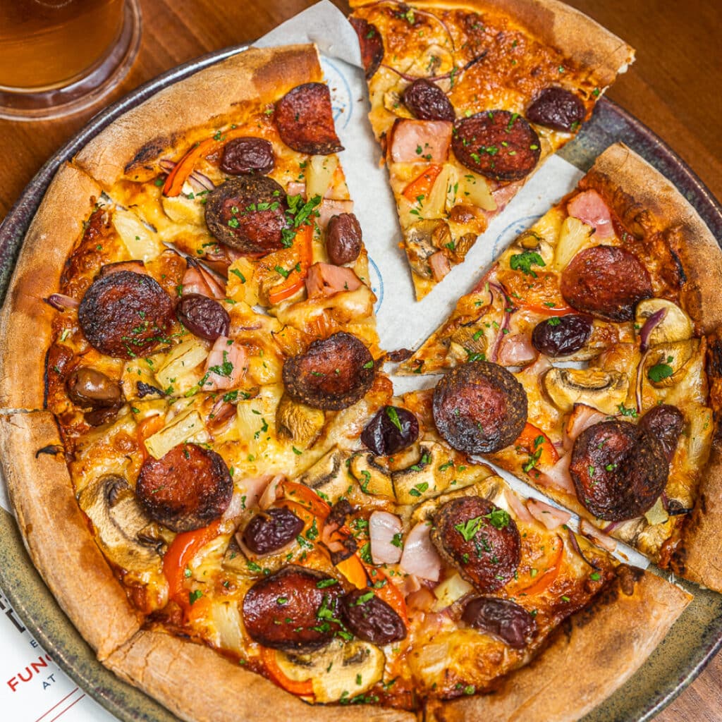 Slice of pepperoni pizza being picked up